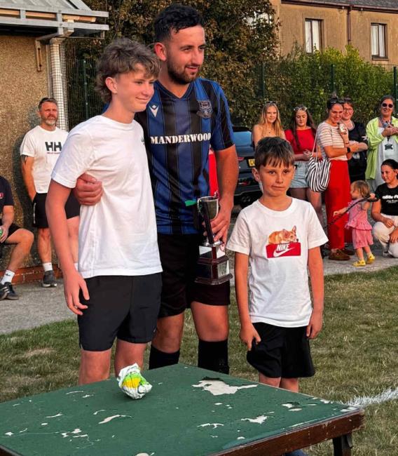 Hakin United captain Jay Power receives the silverware